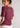 behind Free People's dasy mauve wine T-shirt
