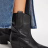 Cowboy Boots Women's Cat Nap Cowboy by Free People, black leather ankle boots worn with denim skirt.