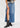 A woman wearing a denim maxi skirt paired with stylish Cowboy Boots Women's, showcasing a chic western look.